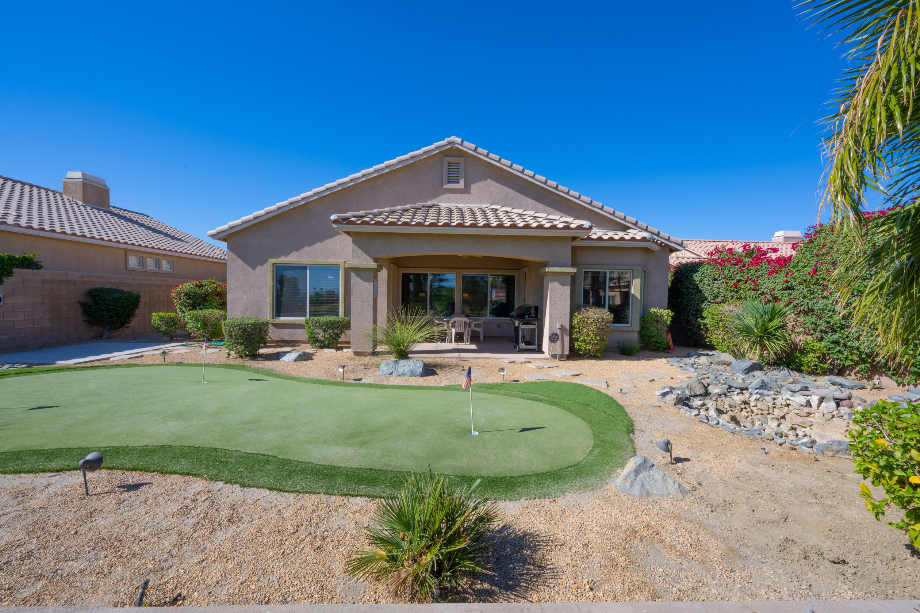 45138 Banff Springs Street Indio, CA 92201 - Photo 21 of 38 a view of a house with backyard porch and sitting area