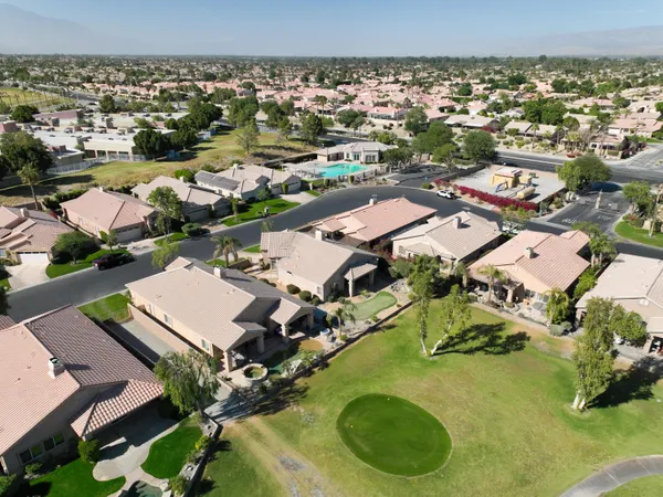an aerial view of residential houses with outdoor space