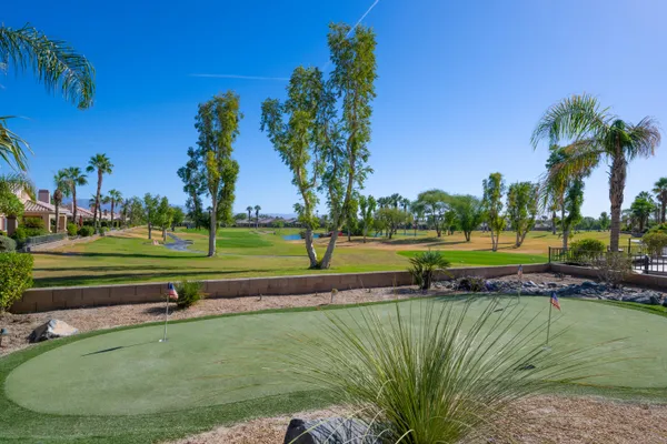 a view of a golf course with a lake view