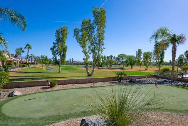 a view of a golf course with a lake view
