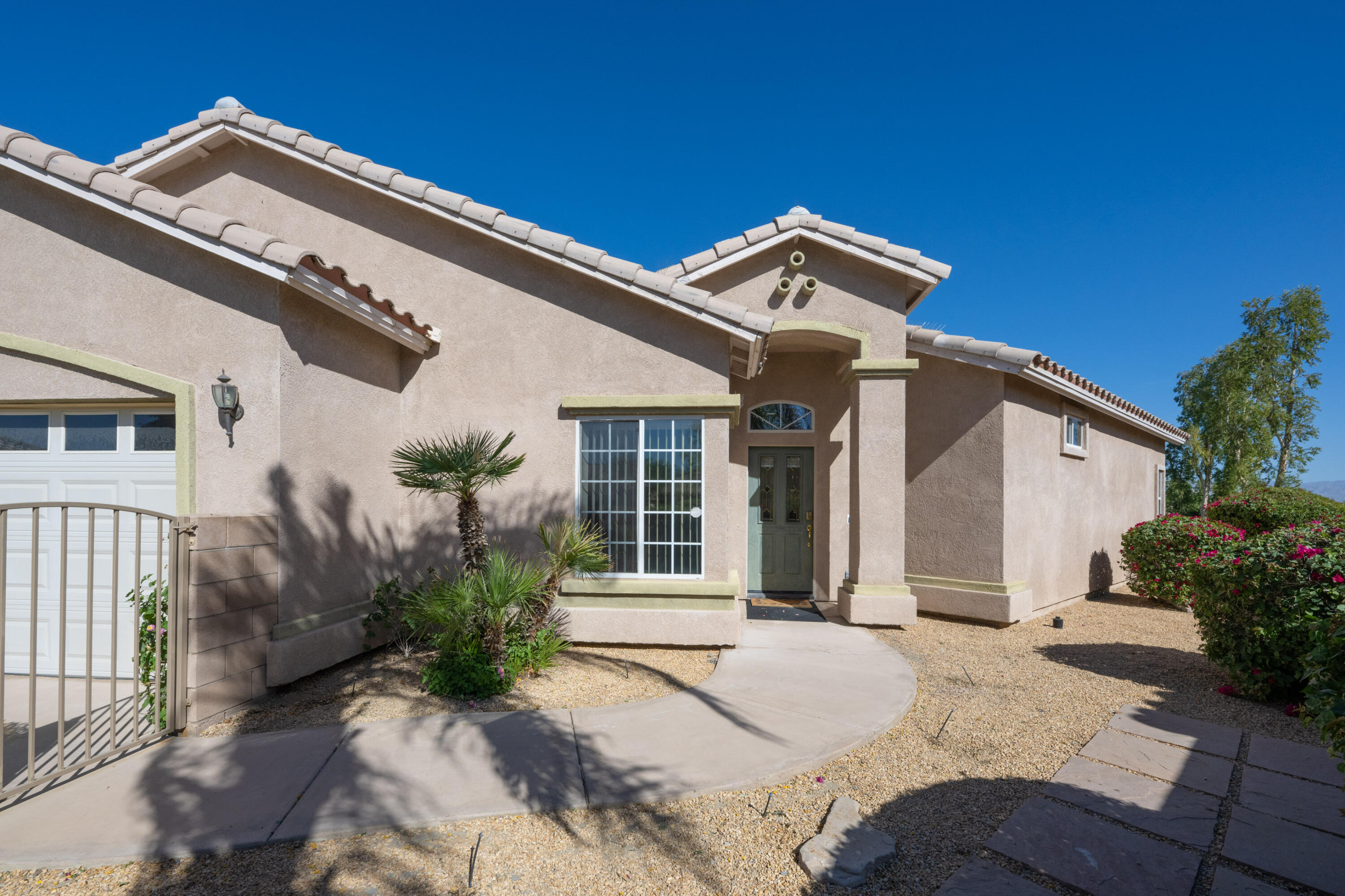 45138 Banff Springs Street Indio, CA 92201 - Photo 5 of 38 a front view of a house with garden