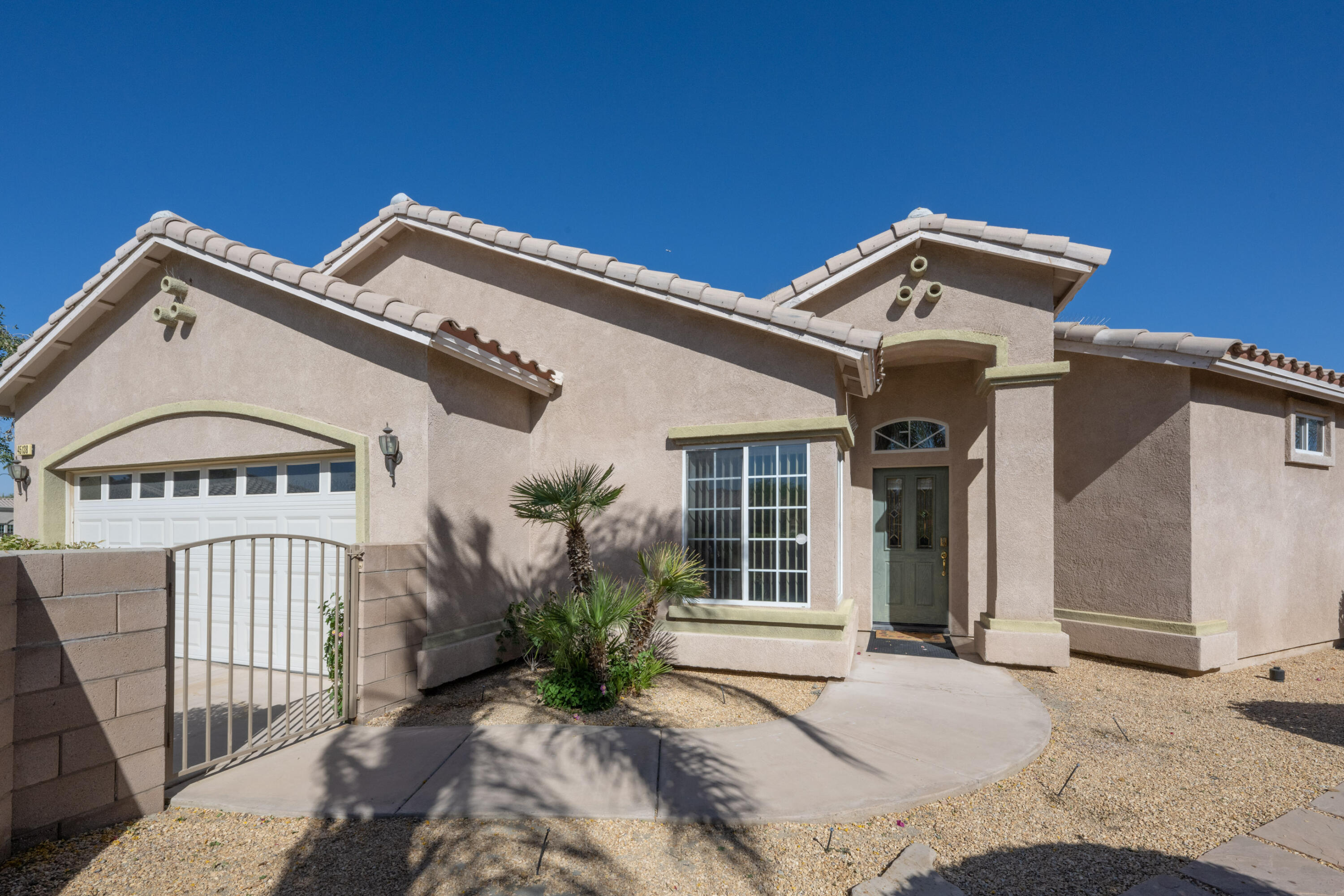 45138 Banff Springs Street Indio, CA 92201 - Photo 6 of 38 a view of a white house with large windows