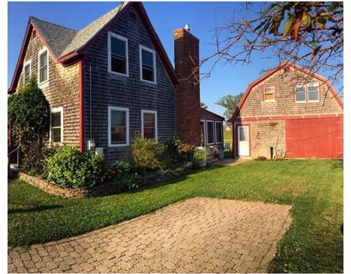 a view of a brick house with a large windows and a yard