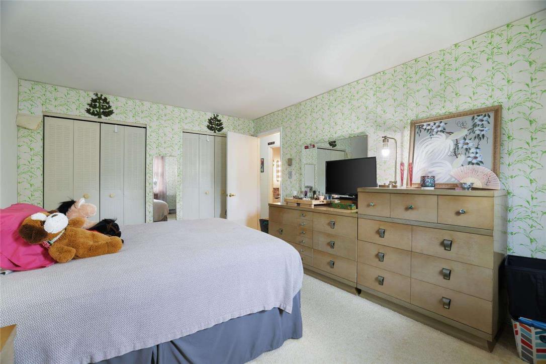 2371 Honeysuckle Road Allentown, PA 18103 - Photo 24 of 25 Double closets and patterned walls define this comfortable secondary bedroom.