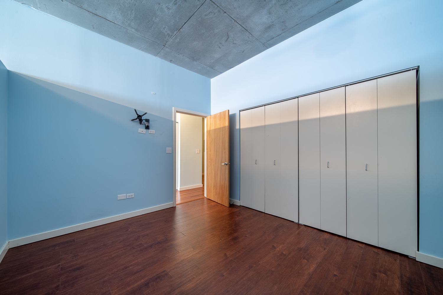 1720 South Michigan Avenue, Unit 2512 Chicago, IL 60616 - Photo 13 of 18 a view of an empty room with wooden floor