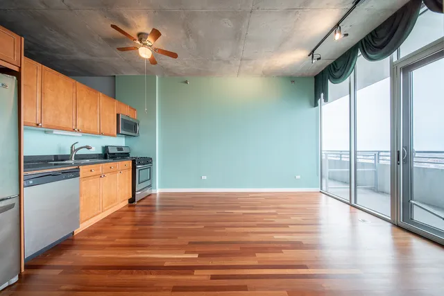 a kitchen with granite countertop a stove and a refrigerator