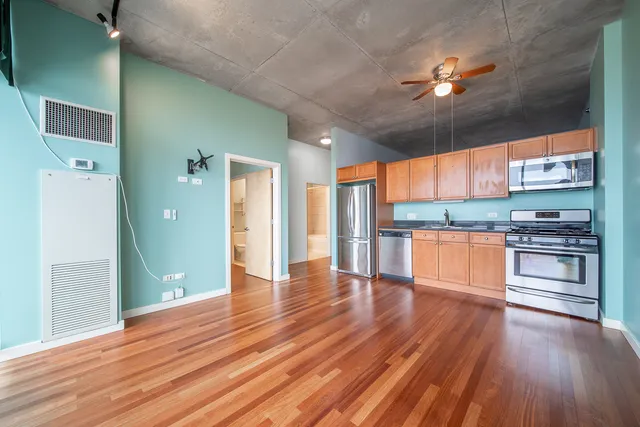 a view of kitchen with cabinets and wooden floor