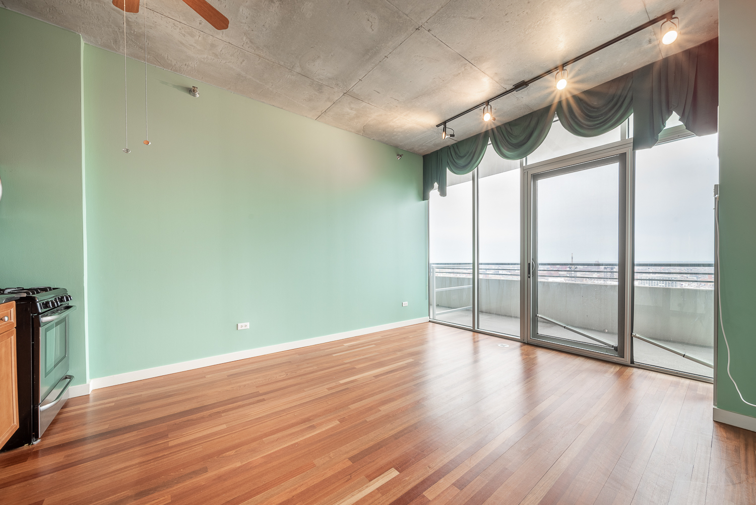 1720 South Michigan Avenue, Unit 2512 Chicago, IL 60616 - Photo 7 of 18 a view of an empty room with wooden floor and a window