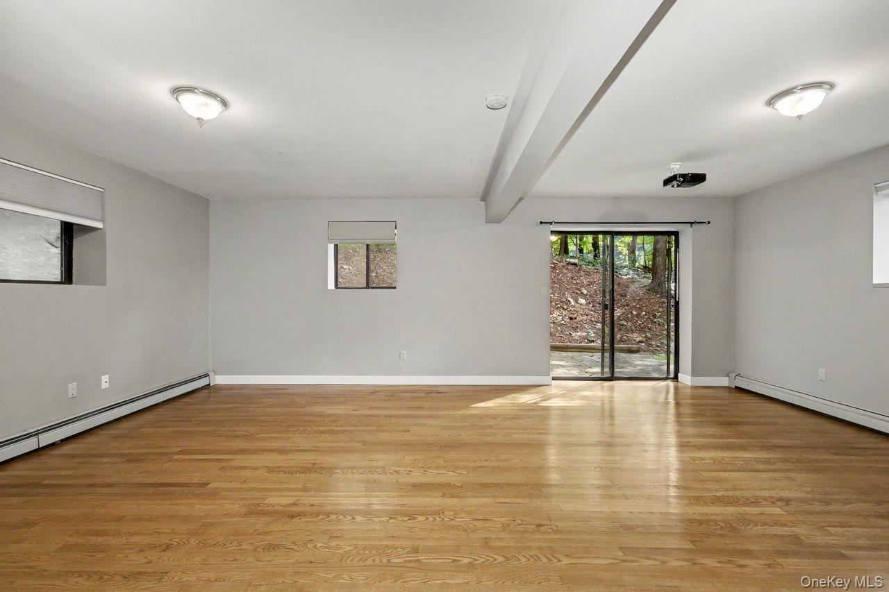 5 Trolley Road Cortlandt Manor, NY 10567 - Photo 29 of 43 Lower level family room with sliding glass doors leading to small side patio.