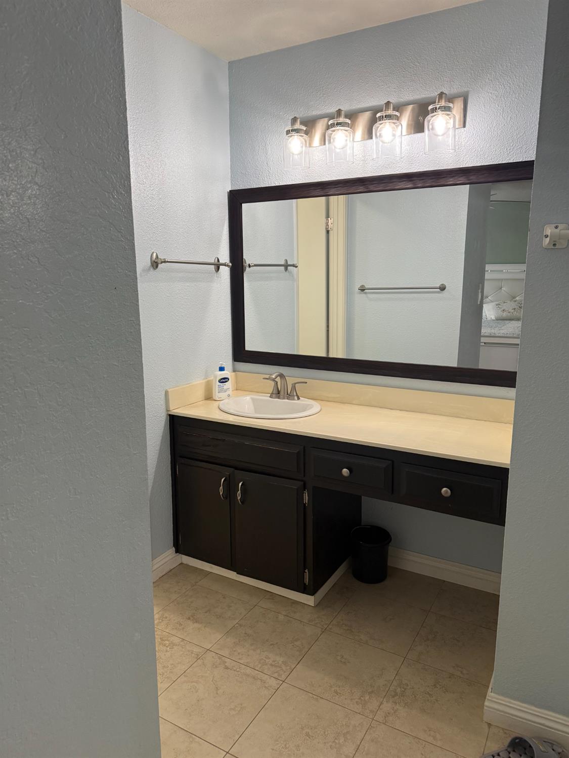 1508 Mable Avenue Modesto, CA 95355 - Photo 18 of 25 a bathroom with a sink vanity and mirror