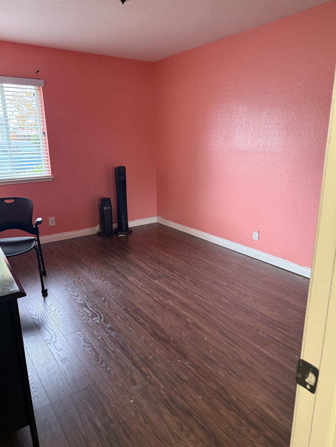 1508 Mable Avenue Modesto, CA 95355 - Photo 19 of 25 a view of an empty room with wooden floor and a window
