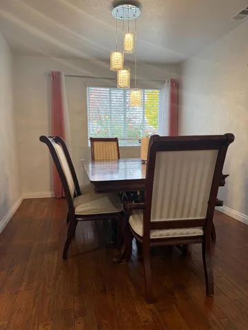 a view of a dining room with furniture window and wooden floor