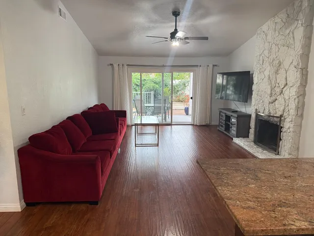 a living room with furniture fireplace and flat screen tv