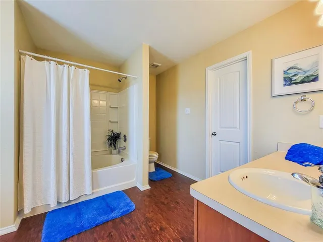 a spacious bathroom with a sink and a mirror