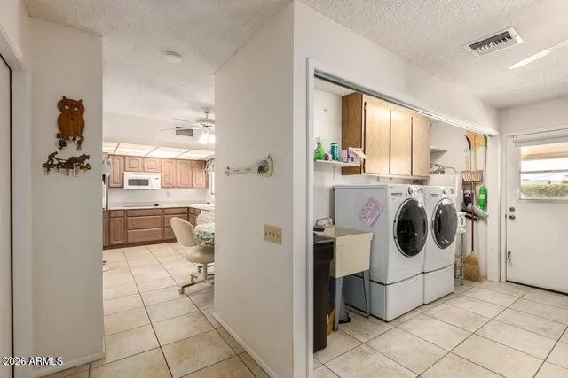 a view of a kitchen with a stove fridge and windows