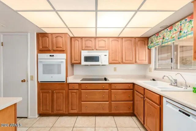 a kitchen with a sink window and cabinets