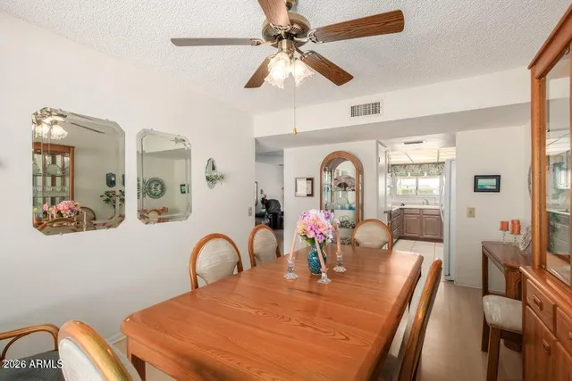 a dining room with furniture a chandelier and a painting