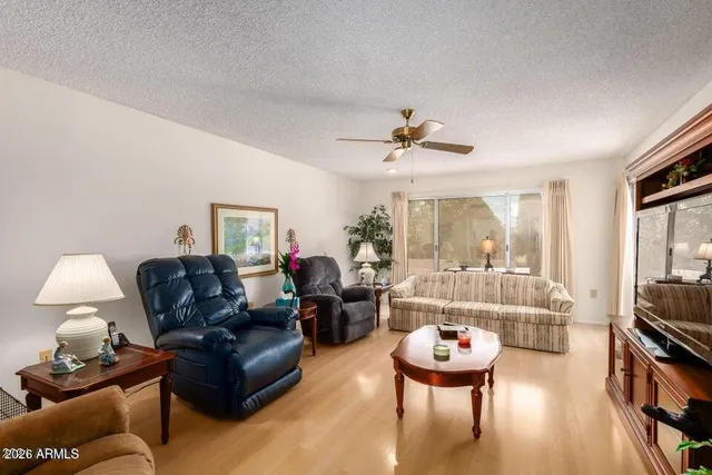 a living room with furniture and a chandelier