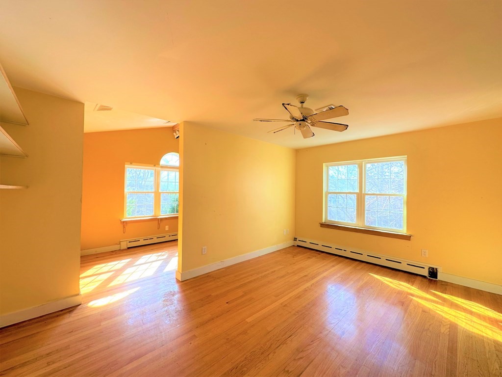 205 Winton Street Springfield, MA 01118 - Photo 17 of 28 a view of a room with wooden floor and a ceiling fan