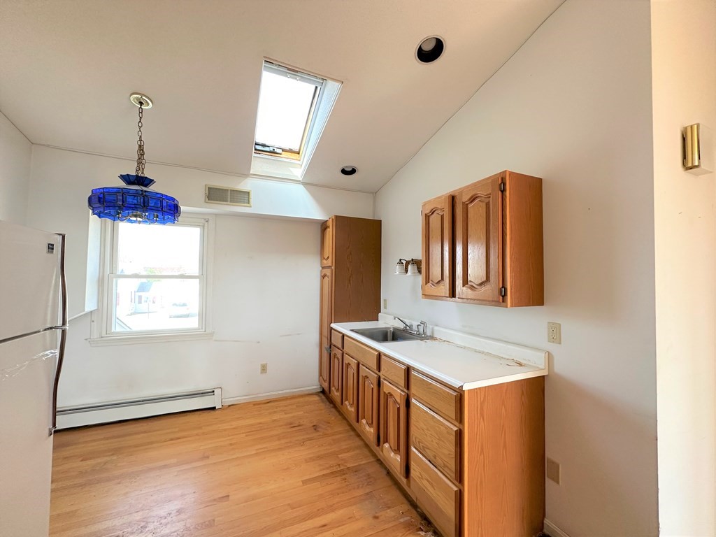 205 Winton Street Springfield, MA 01118 - Photo 23 of 28 a kitchen with stainless steel appliances granite countertop a sink stove and a refrigerator