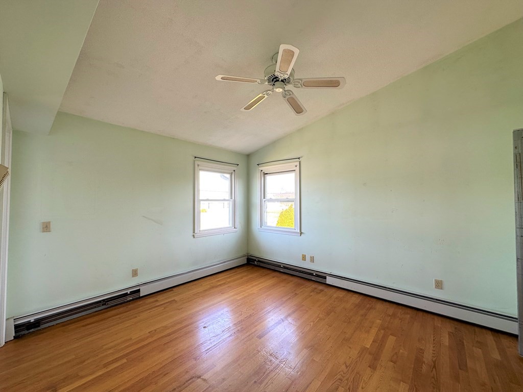 205 Winton Street Springfield, MA 01118 - Photo 24 of 28 an empty room with a window and wooden floor