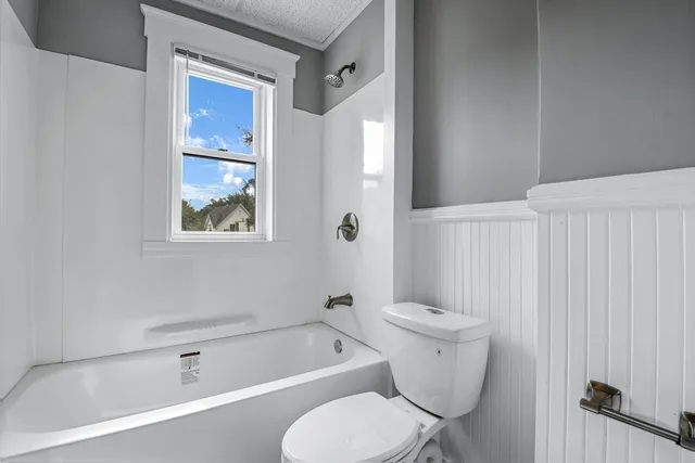a bathroom with a toilet a sink and bathtub