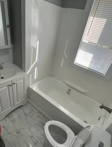 a bathroom with a sink a toilet and bathtub