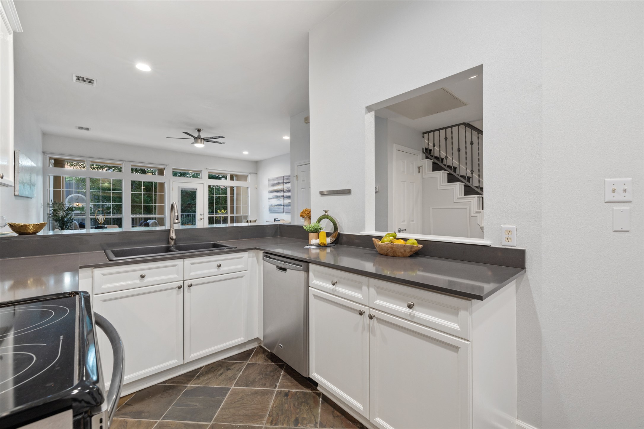2918 Ranch To Market Road 620, Unit O282 Austin, TX 78734 - Photo 14 of 40 Kitchen featuring dark countertops, electric stove, stainless steel dishwasher, a sink, and ceiling fan