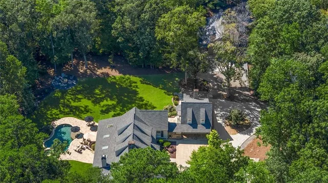 an aerial view of house with yard swimming pool and outdoor seating