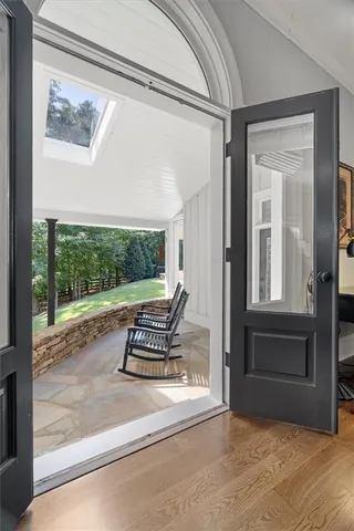 a view of a patio with a table chairs and a yard