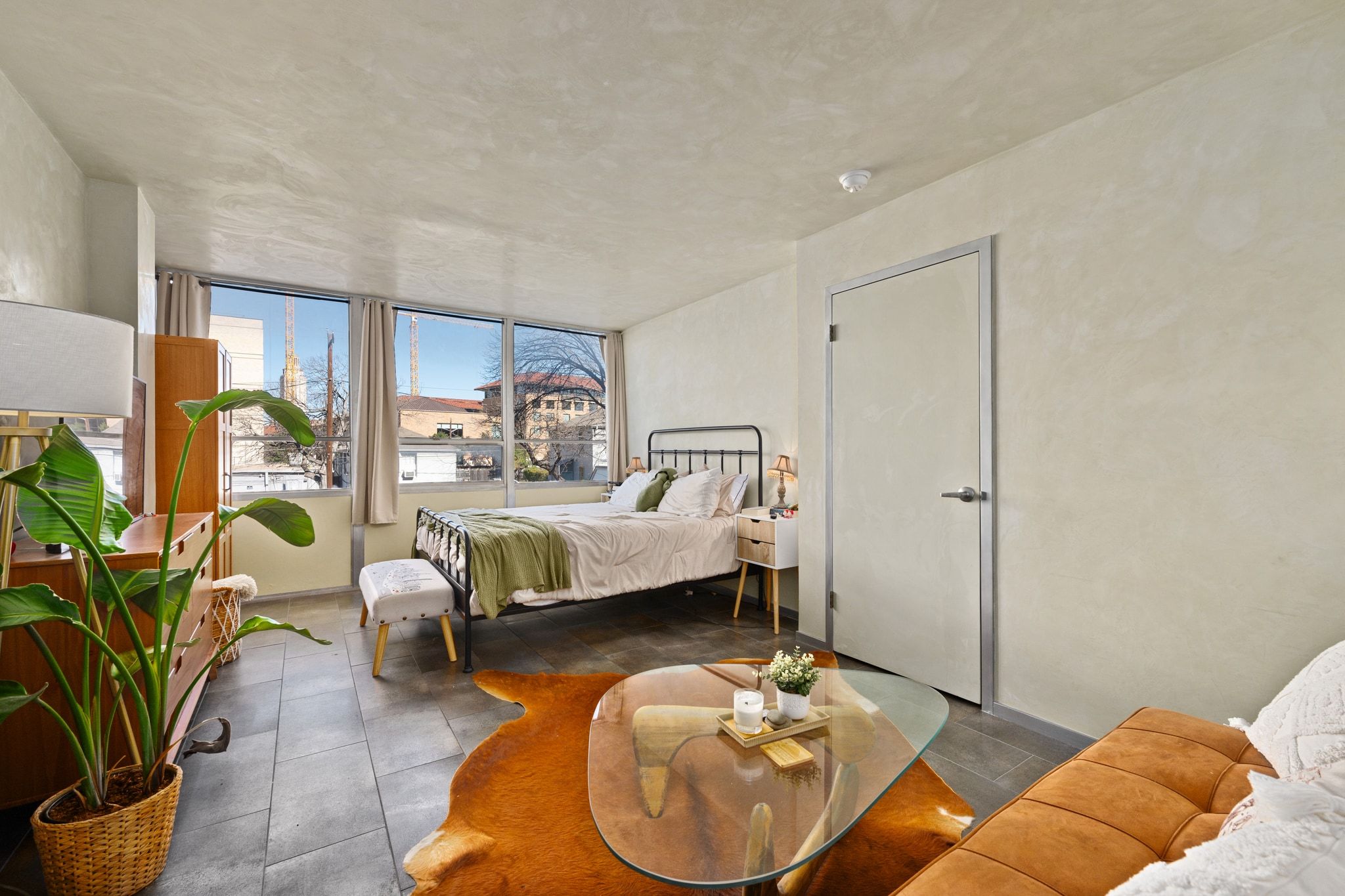 1800 Lavaca Street, Unit A208 Austin, TX 78701 - Photo 10 of 20 a bedroom with bed and a couch