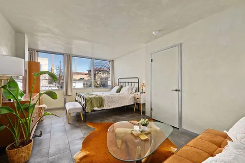 a bedroom with a bed and a window