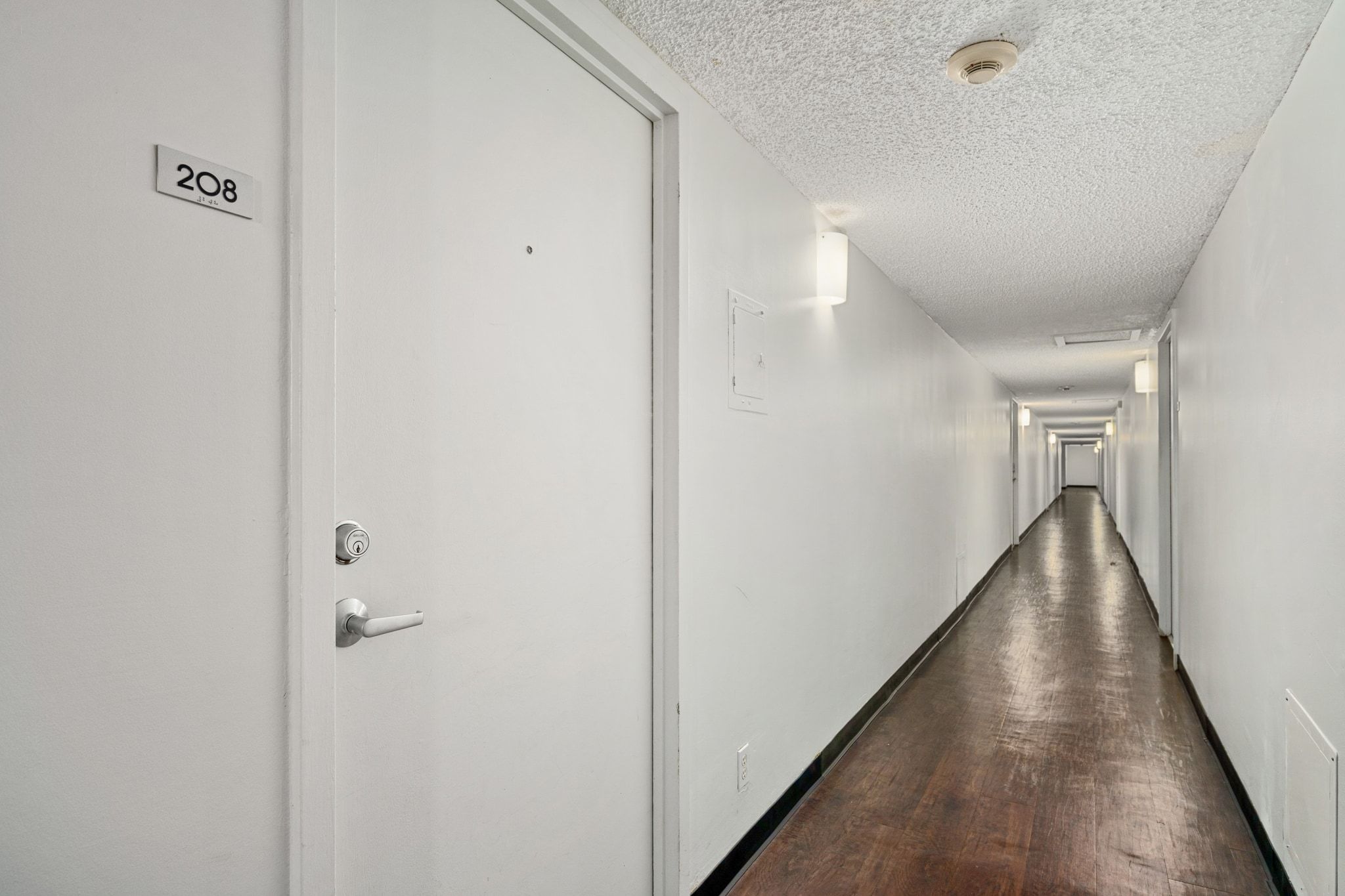 1800 Lavaca Street, Unit A208 Austin, TX 78701 - Photo 19 of 20 a view of a hallway with the wooden floor