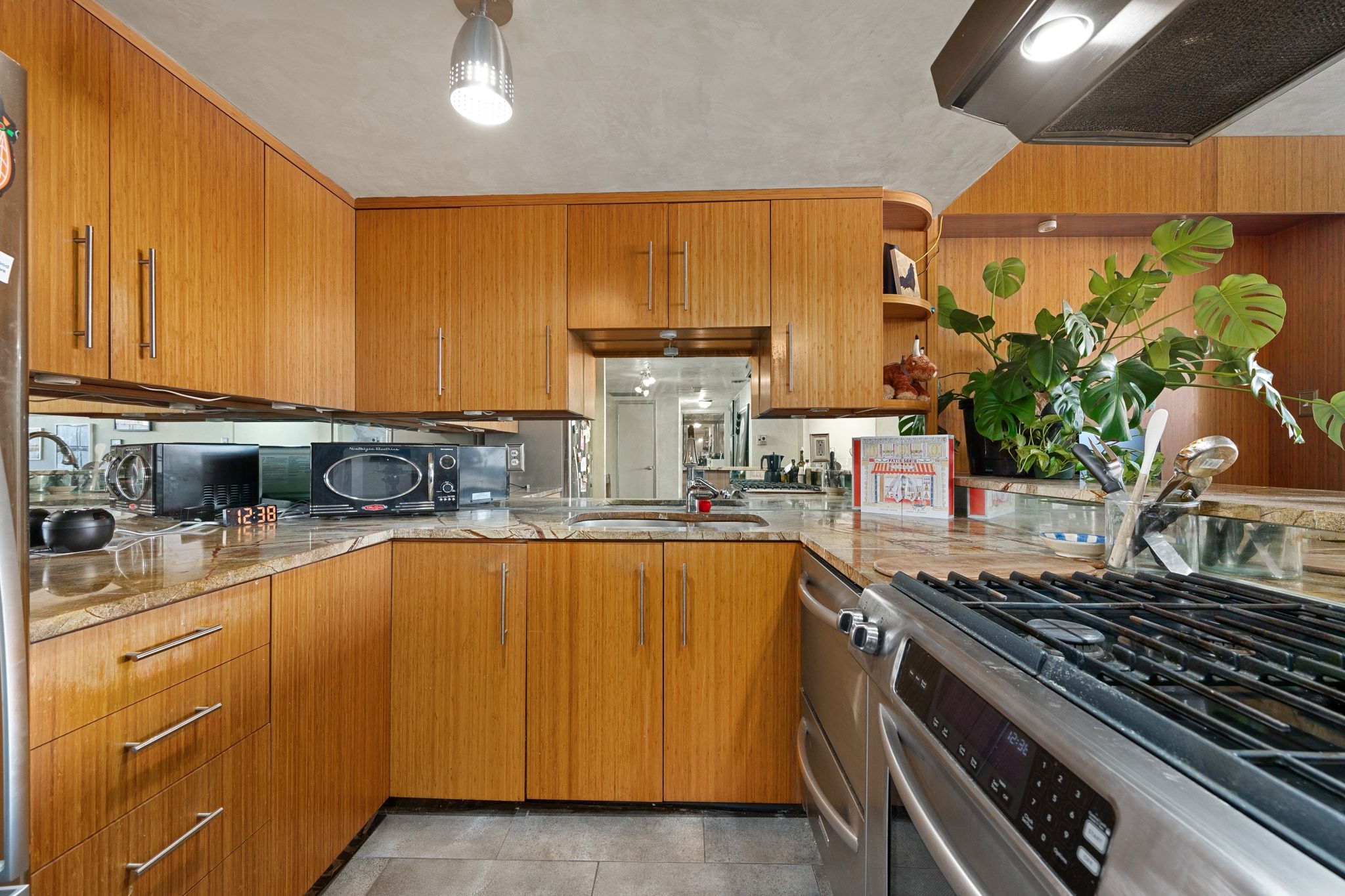 1800 Lavaca Street, Unit A208 Austin, TX 78701 - Photo 5 of 20 a kitchen with stainless steel appliances a sink stove and cabinets