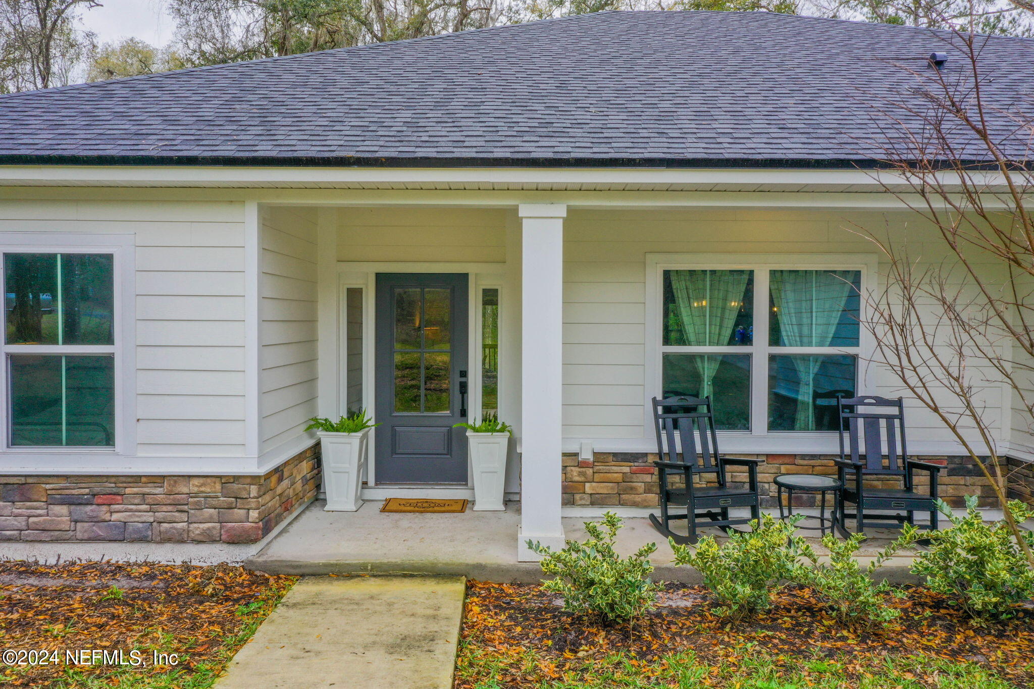 2558 Crooked Creek Point Road Middleburg, FL 32068 - Photo 6 of 56 a front view of a house with garden