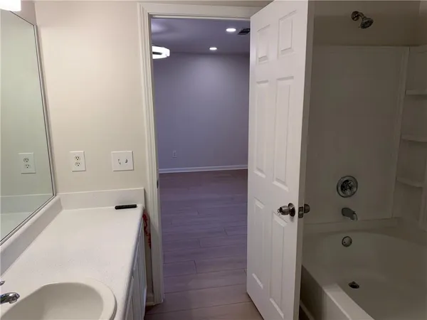 a bathroom with a tub and shower