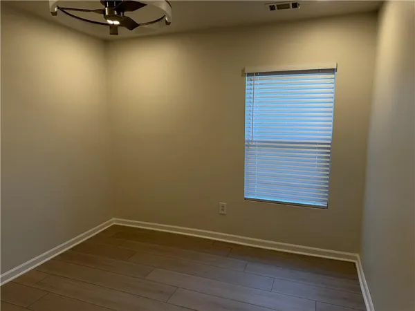 a view of a room with rack on the wall and a window