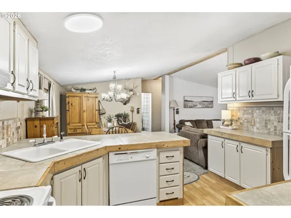 a kitchen with stainless steel appliances kitchen island granite countertop a sink and cabinets