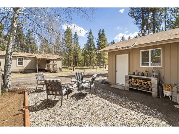 a view of a house with backyard and sitting area