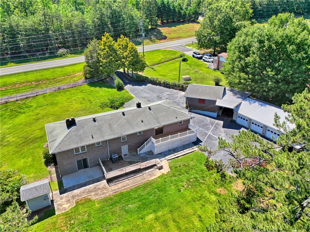 7876 Highway 11 Walhalla, SC 29691 - Photo 7 of 35 An aerial view showcases a brick residence with an attached garage and expansive grounds.