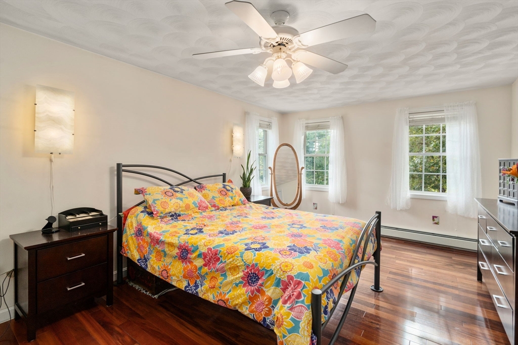 30 Martin Road Douglas, MA 01516 - Photo 14 of 33 a bedroom with a bed and a chandelier