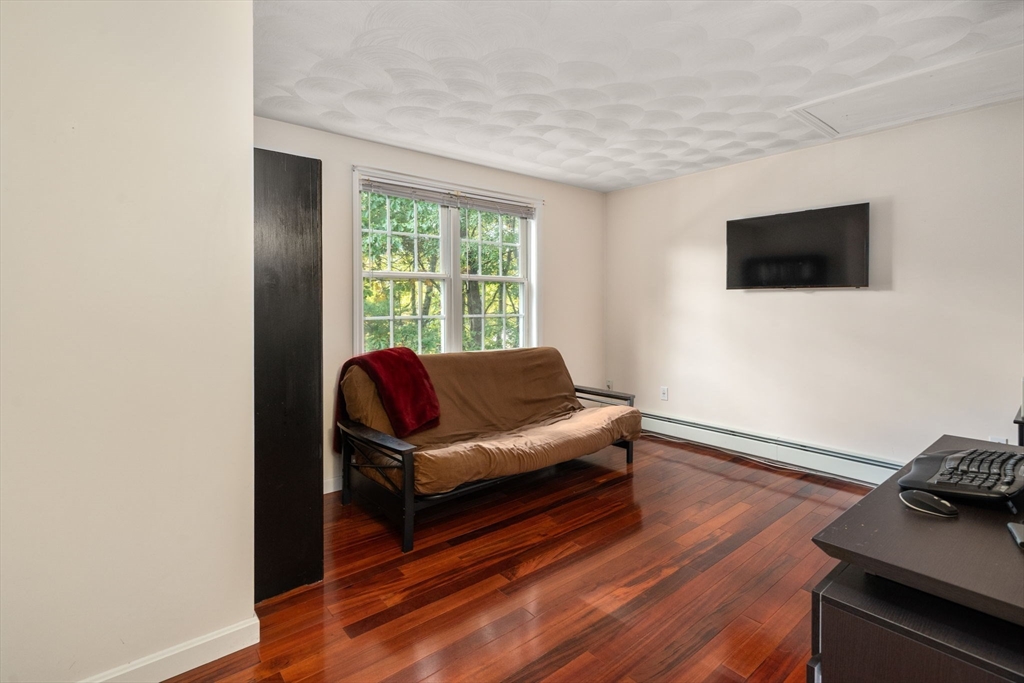 30 Martin Road Douglas, MA 01516 - Photo 17 of 33 a living room with furniture and a flat screen tv