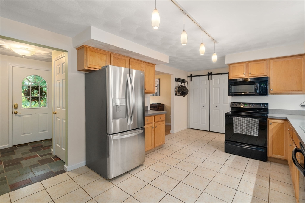 30 Martin Road Douglas, MA 01516 - Photo 8 of 33 a kitchen with stainless steel appliances a refrigerator and a stove top oven