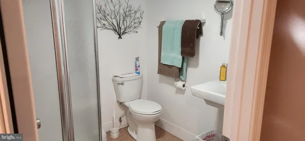 a white toilet sitting next to a bathroom sink