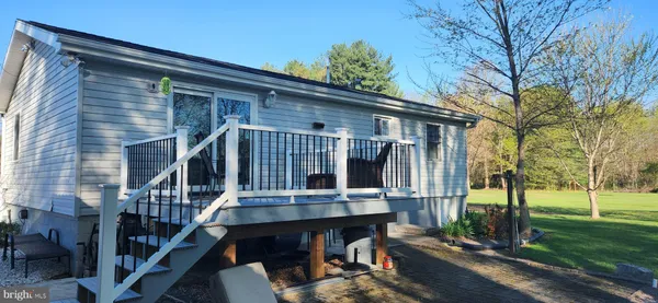 a backyard of a house with barbeque oven table and chairs
