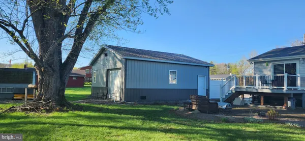 a backyard of a house with fountain table and chairs