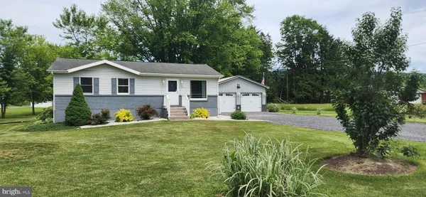 a view of front of house with a yard