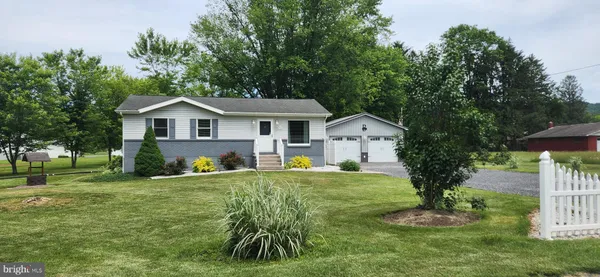 a front view of house with yard and green space