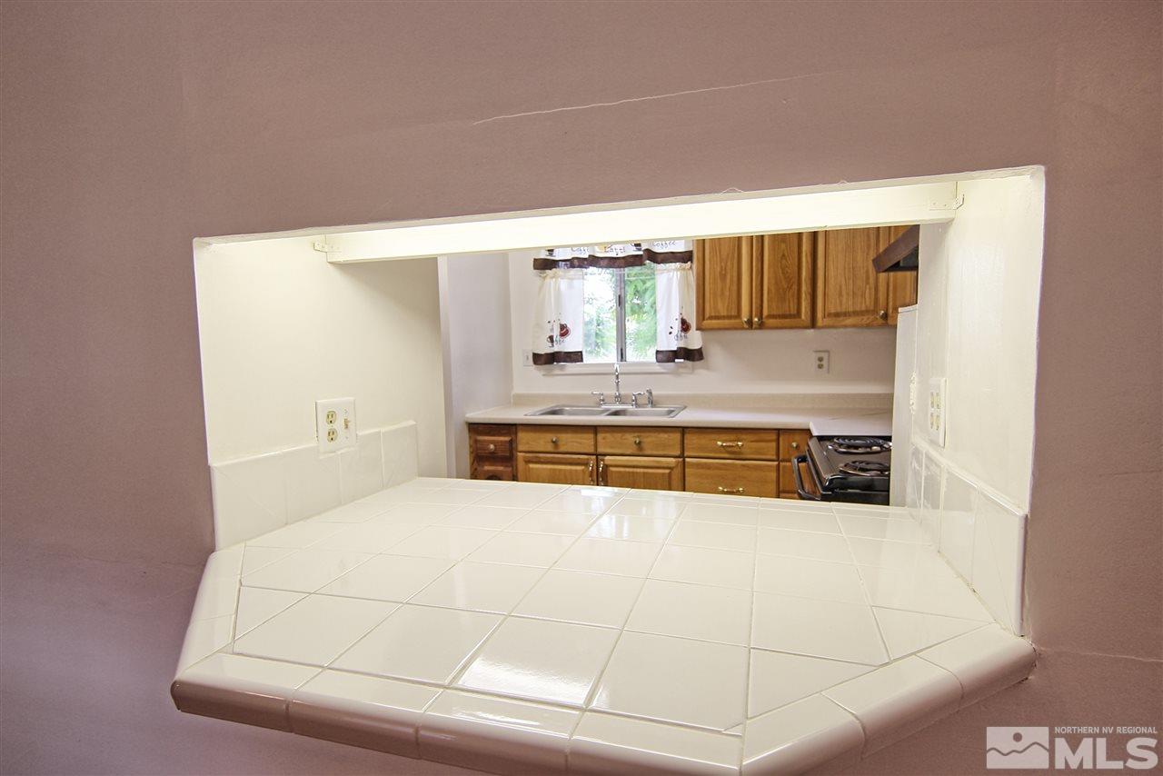4575-4571 Alcorn Road Fallon, NV 89406 - Photo 20 of 25 a bathroom with a tub sink and mirror