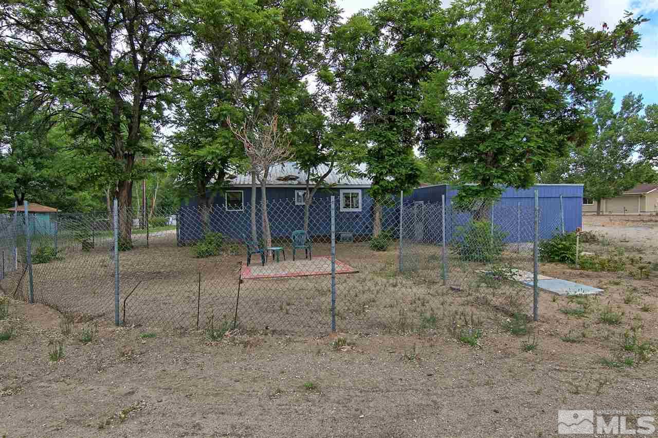 4575-4571 Alcorn Road Fallon, NV 89406 - Photo 7 of 25 a backyard of a house with plants and tree